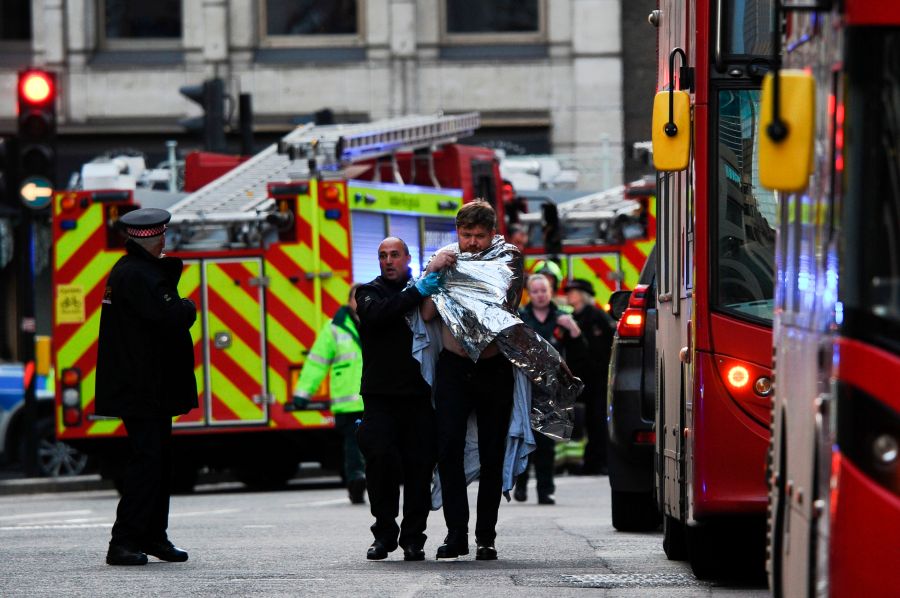 Police assist an injured man after a stabbing attack on the London Bridge on Nov. 29, 2019. (Credit: Daniel Sorabji / AFP / Getty Images)